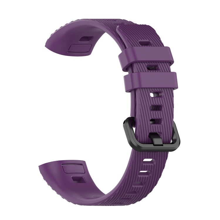 Purple silicone watch strap with ridged texture and adjustable buckle
