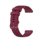 Wine red silicone wristband with textured perforations and adjustable metal clasp