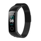 Black milanese watch strap with fitness watch displaying time and date numbers.