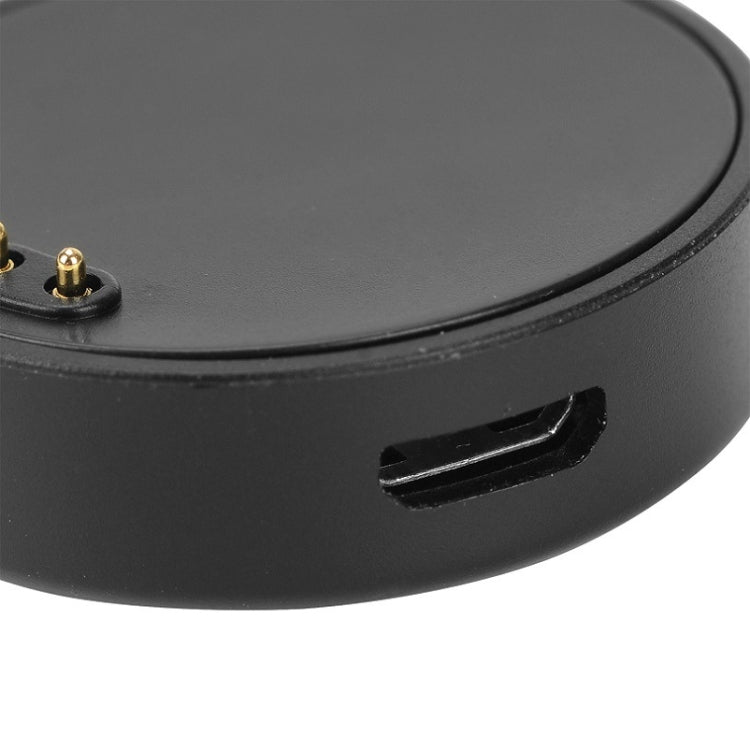 Black round charging puck with open port slot for smartwatch charging