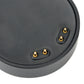 Black round charging puck with three gold contact pins for smartwatch charging