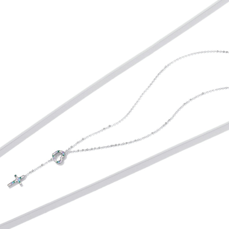 Silver necklace with heart pendant and small cross charm, blue and clear stones