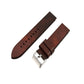 Brown leather watch strap with quick-release buckle and adjustment holes