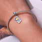 Sterling silver bracelet on wrist with mesh chain and tarot card sun charm in blue and yellow