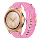 Pink nylon canvas watch strap with metal buckle, worn on a round smartwatch