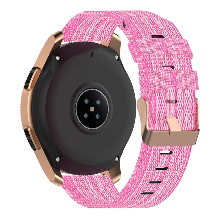 Pink nylon canvas watch strap with metal buckle, worn on a smartwatch