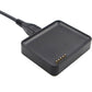 Black watch charging base with gold pin contacts and attached charging cable.