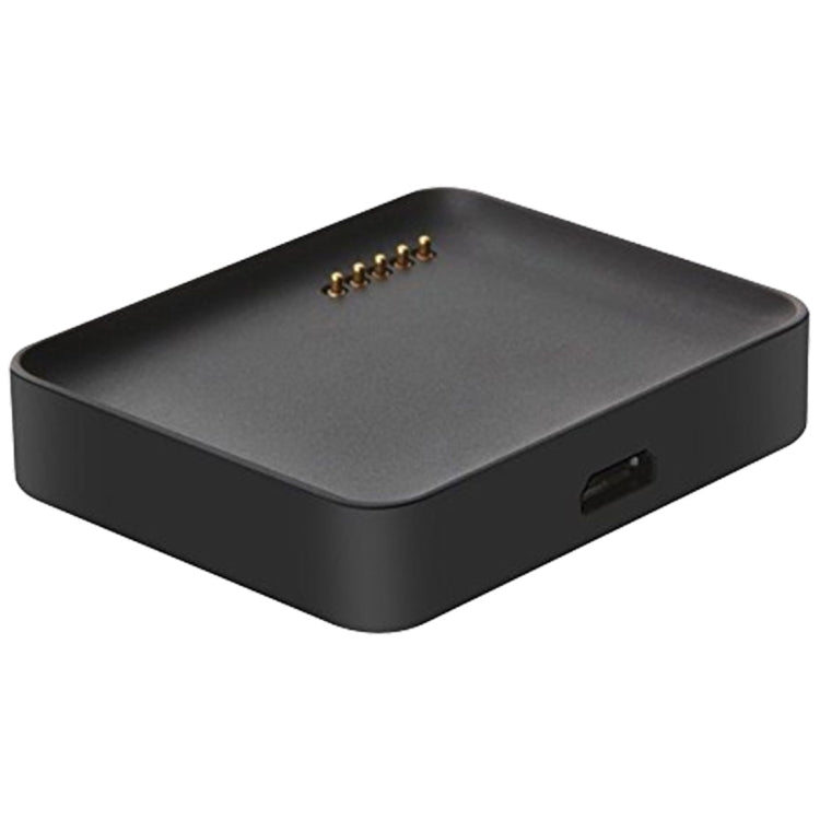 Black watch charger dock with USB port and gold pin contacts.
