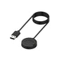 Black coiled USB charging cable with round dock and pin contacts.