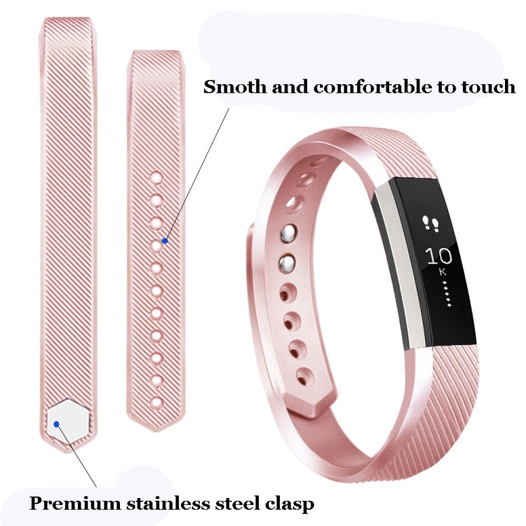 Rose gold metallic watch band with clasp, textured strap and row of adjustment holes
