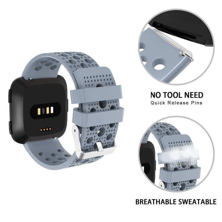 Breathable perforated TPU watch strap with quick-release for Fitbit Versa, light blue.