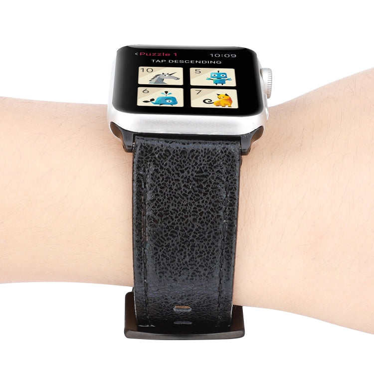 Black glitter leather watch band on wrist, perforated strap with buckle