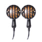 Black retro LED turn signal pair, front view of amber ribbed lenses with glowing bars.