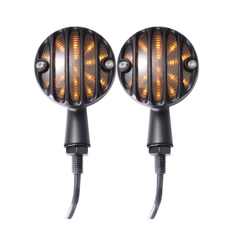 Black retro LED turn signal pair, front view of amber ribbed lenses with glowing bars.