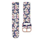 Floral silicone watch band with rose-gold buckle and clasp, dark navy background.