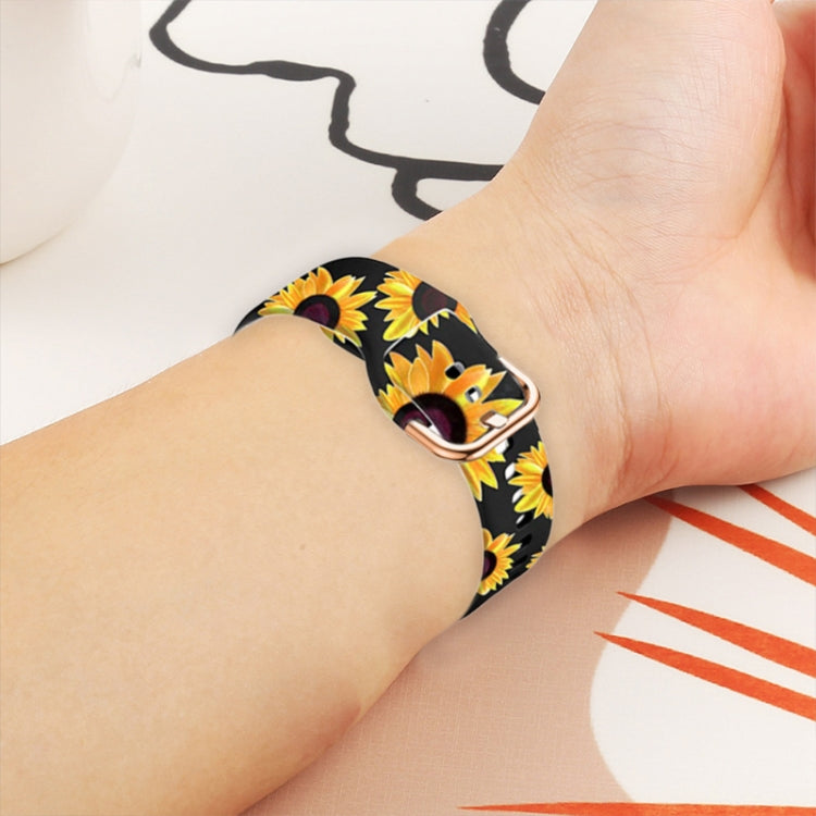 Silicone watch band on wrist with black sunflower print and rose-gold clasp