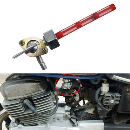 Motorcycle fuel petcock valve with red lever and brass body, angled for installation
