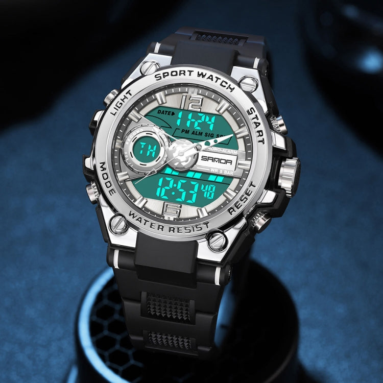 Silver and black digital sports watch with round bezel, luminous digits, rubber strap