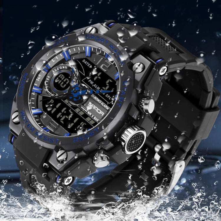 Black digital sports watch with round bezel, multi-dial display, shown in water splashes