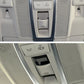 Installed car dome light switch button on overhead console next to sunroof controls