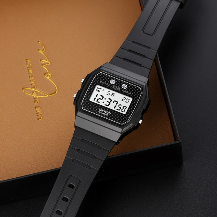 Black digital sports watch with square resin case and linked bracelet, display visible