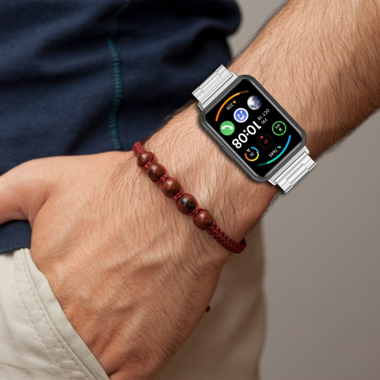 Three-bead metal watch band worn on wrist, silver links with dark strap colorway
