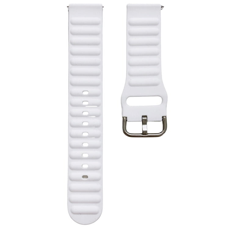 White silicone watch band with ridged texture and metal pin buckle, close-up.