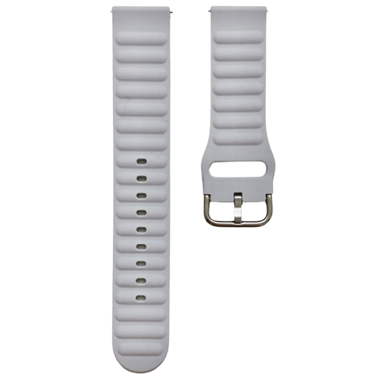 Light gray silicone watch band with ridged texture and metal pin buckle, close-up.