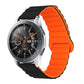 Smart watch with orange silicone band and metal clasp, round black dial with orange details