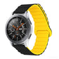 Smart watch with yellow silicone band and metal clasp, round black dial with orange details
