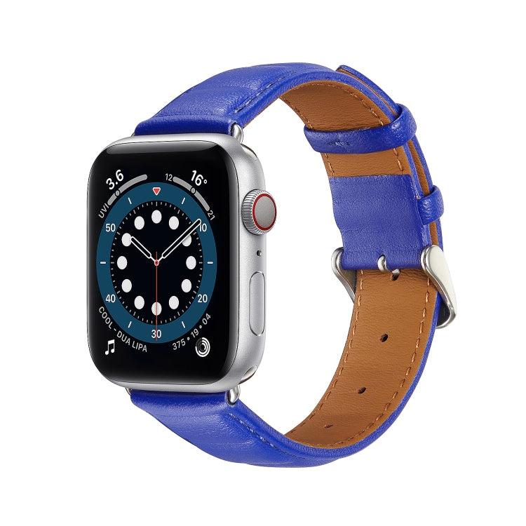 Blue genuine leather Apple Watch band with metal buckle and tan underside on watch