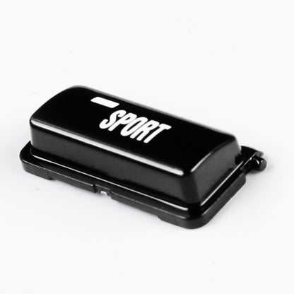 Black sport mode button with SPORT logo on top