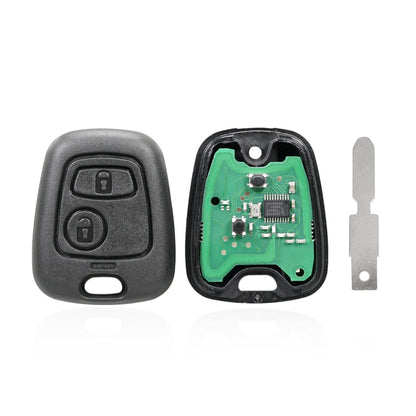 Two-button car key fob with dark gray shell, internal circuit board, and metal blade