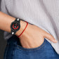 Black silicone watch band with red stripe, worn on wrist