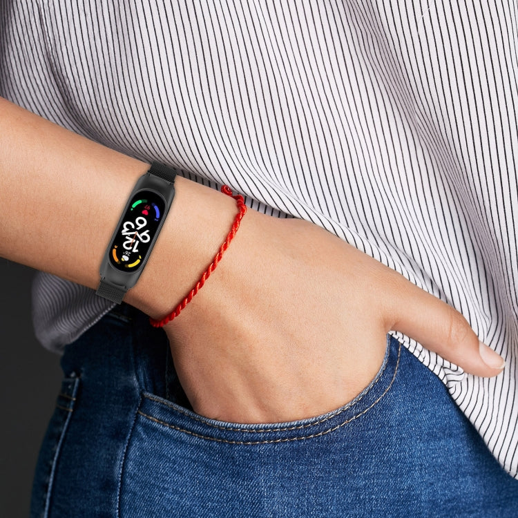 Black Milan metal watch band worn on wrist, compatible with Xiaomi Mi Band 7/7NFC