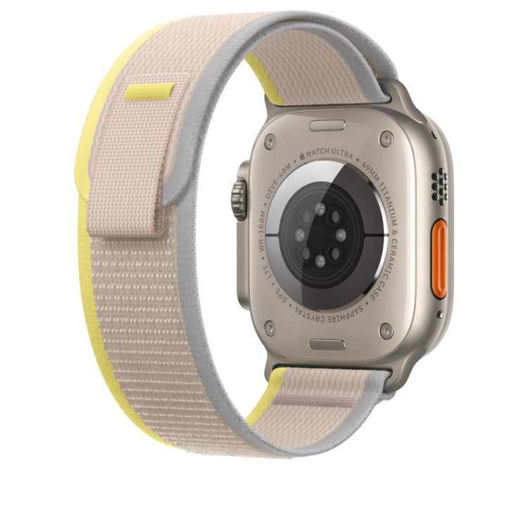 Beige nylon watch band with Apple Watch back and side button, textured strap.