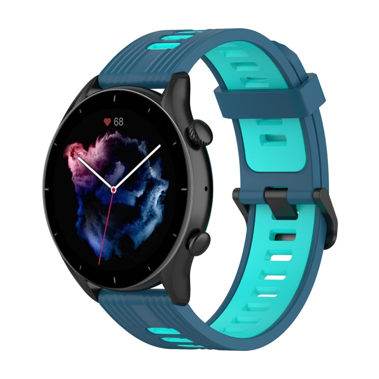 Two-color silicone watch band with teal strap and dark blue buckle-style clasp.