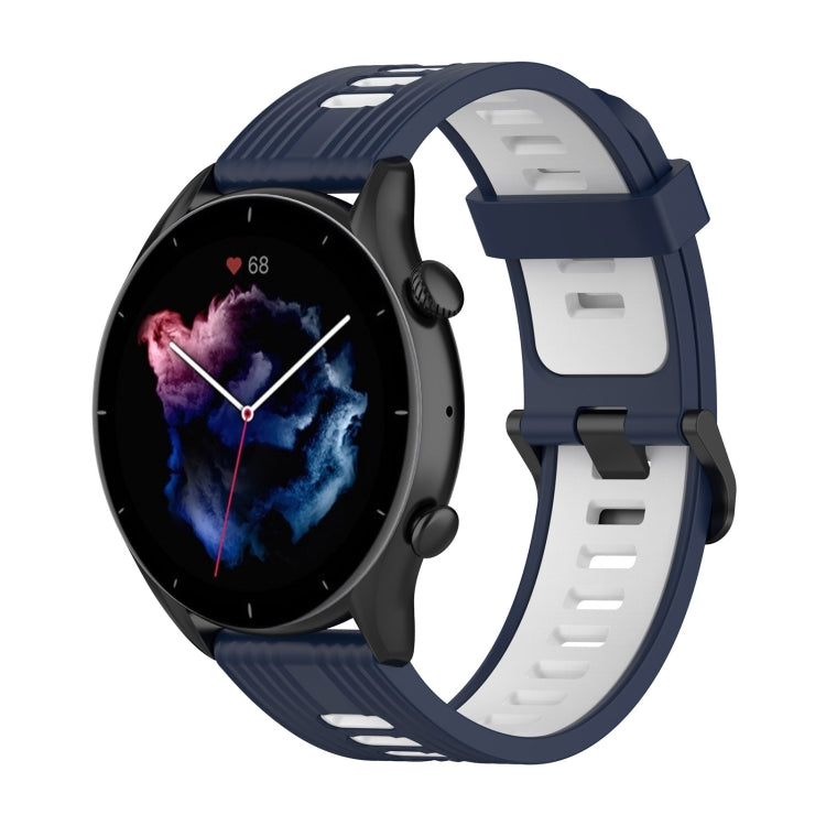 Two-color silicone watch band with navy strap and dark blue buckle-style clasp.