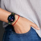 Silicone watch band on wrist in black with neon green accents and clasp.