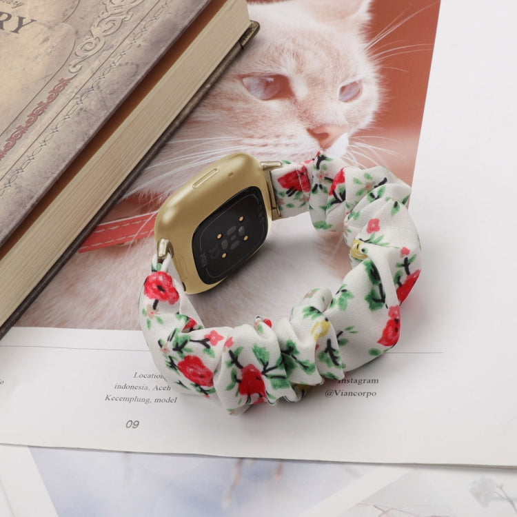 Floral cloth watch band in white with red flowers and green leaves; smartwatch and pet shown.