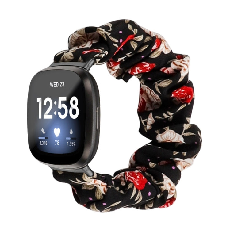 Black floral cloth watch band with red blossoms and cream leaves; smartwatch shown.