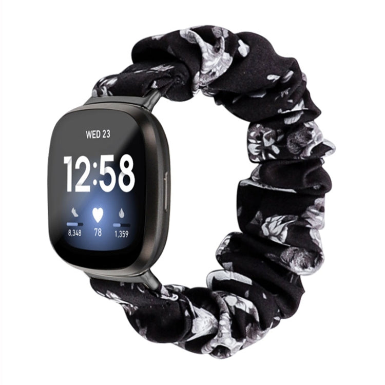 Black cloth watch band with gray and white floral print; smartwatch shown.