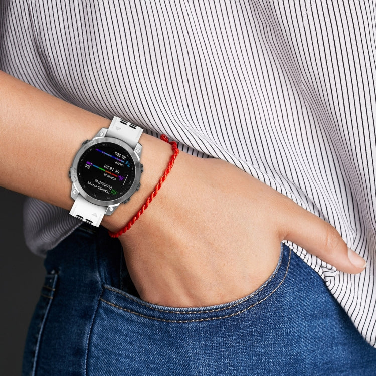 White perforated double-row silicone watch band with red quick-release strap on wrist
