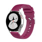 Magenta silicone watch band with pockmarked silver buckle and perforated strap holes