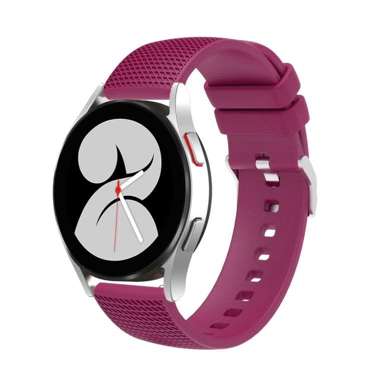 Magenta silicone watch band with pockmarked silver buckle and perforated strap holes