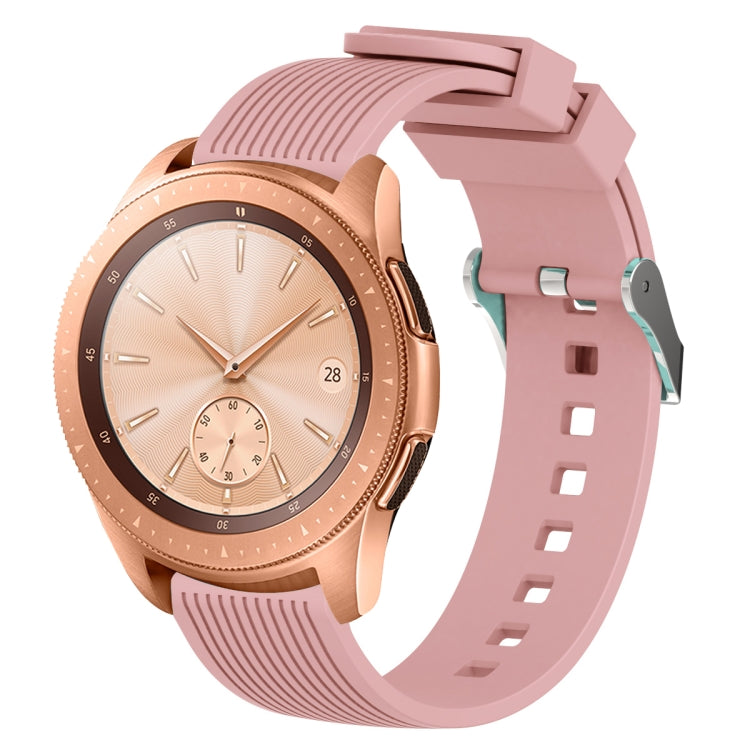Pink silicone watch band with vertical grain texture, buckle clasp, and strap holes
