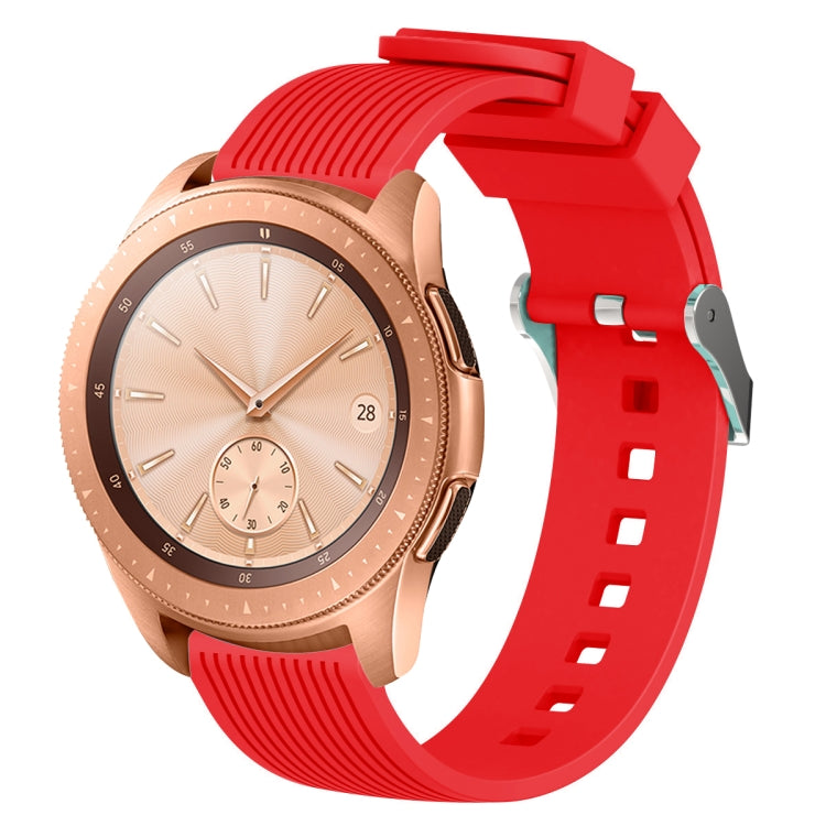 Red silicone watch band with vertical grain texture, buckle clasp, and strap holes