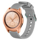 Grey silicone watch band with vertical grain texture, buckle clasp, and strap holes