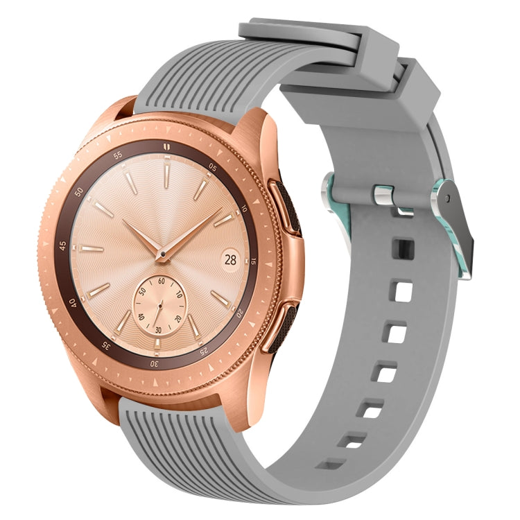 Grey silicone watch band with vertical grain texture, buckle clasp, and strap holes