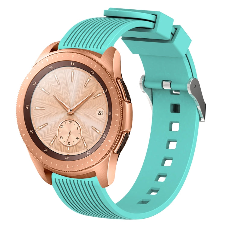 Mint green silicone watch band with vertical grain texture, buckle clasp, and strap holes
